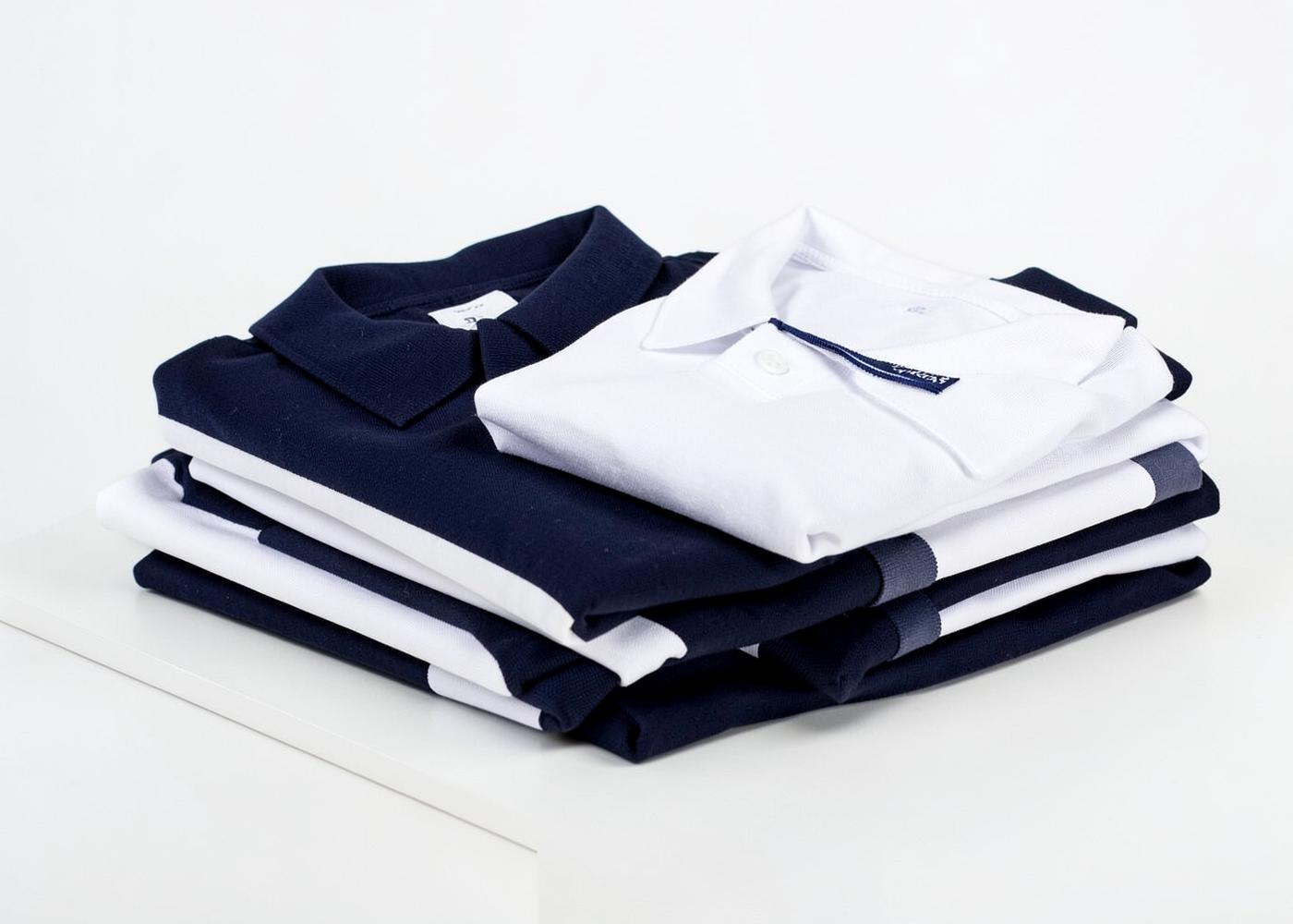 Folded navy and white school uniform polos (placeholder image)